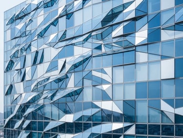 Abstract geometric pattern of blue and white glass panels representing structured data flow, sharp clean shadows.