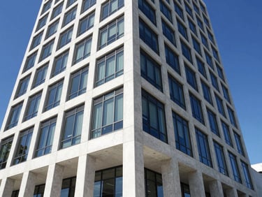 Low-angle architectural perspective of a newly completed modern commercial building in Tampa, clean lines, pristine concrete and glass, bright daylight.