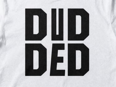 Flat-lay overhead of a custom T-shirt design on a clean white surface, bold graphic print centered, even studio strobe lighting, crisp fabric texture visible, no background distractions