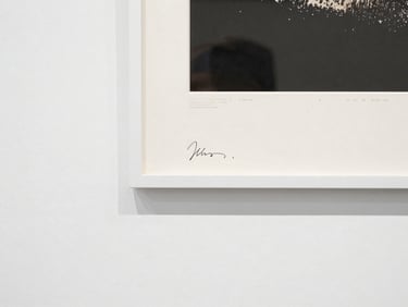 Close-up of the edge of a large-format archival pigment print, mounted on dibond, showing the artist's signature and edition number on the reverse, with a certificate of provenance.
