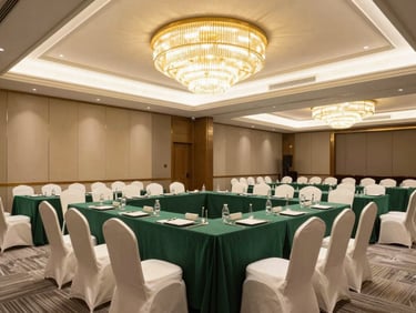 Modern corporate conference setup in a luxury banquet hall, clean lines, emerald accents, bright professional lighting