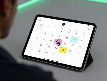 Over-the-shoulder view of a tablet displaying a colorful family calendar application, soft studio lighting, crisp details, shallow depth of field