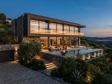 Luxury modern villa exterior with warm lighting, natural stone walls, large glass windows reflecting twilight sky, 8k resolution