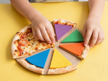 A close-up of a child's hands placing cardboard pizza slices together on a bright yellow surface, learning fractions, bright high-key editorial photography, cheerful natural daylight, vibrant primary colors, shallow depth of field
