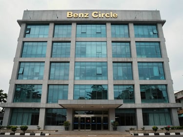 Ground-level exterior shot of a four-storey commercial office building on Benz Circle, Vijayawada, glass-and-concrete facade, overcast daylight, building entrance visible at centre