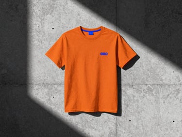 High-contrast campaign mockup of an apparel brand on a brutalist concrete wall, sharp shadows, 35mm film grain