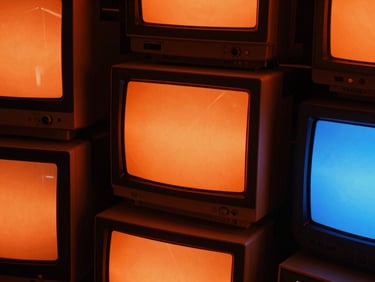 Close-up macro crop of digital advertising dashboards on vintage CRT monitors, high-contrast orange glow, sharp shadows, raw aesthetic.