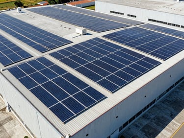 Drone view of massive industrial warehouse roof in São Paulo covered in solar panels under bright direct sunlight, 35mm