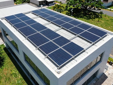 Aerial drone perspective of clean solar panels installed on a modern flat roof in São Paulo, bright direct sunlight, vibrant blue and green tones, crisp architectural photography, 35mm