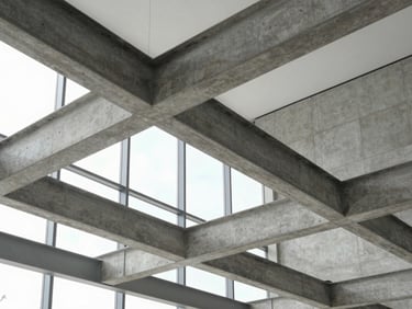 Modern architectural detail of concrete and steel beams inside a Silicon Valley office, bright indirect daylight, cool desaturated tones