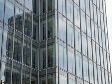 Modern architectural detail of an office glass facade in Silicon Valley, clean reflections, daylight