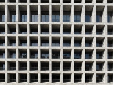 Symmetrical straight-on architectural shot of a modern concrete building facade, crisp daylight, sharp lines, structural grid pattern