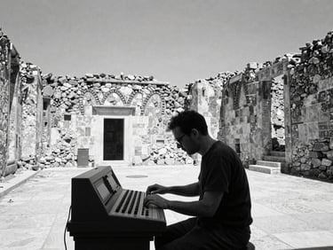 An artist in deep concentration adjusting dials on an electronic console inside a historic stone ruin, stark midday sun.