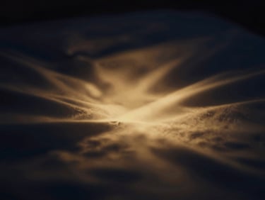 Abstract image of a calm, serene mind symbolized by soft, flowing golden light on a dark background, evoking a starry night, with deep navy and gold tones, shallow depth of field, 35mm.