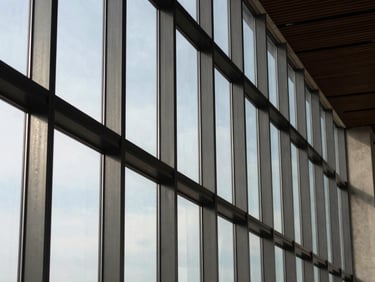 Crisp architectural daylight on a custom steel-framed window system, highlighting ultra-narrow sightlines.