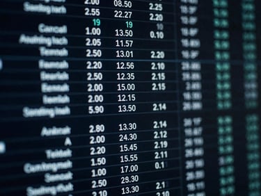 High-contrast close-up of a digital interface showing performance metrics, cool blue screen glow, sharp focus on data columns, desaturated dark tones.