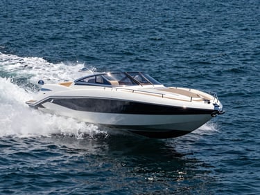 Action shot of a high-performance luxury speedboat slicing through deep blue Gulf waters, water spraying from the hull, polished chrome details reflecting high-contrast midday sun.