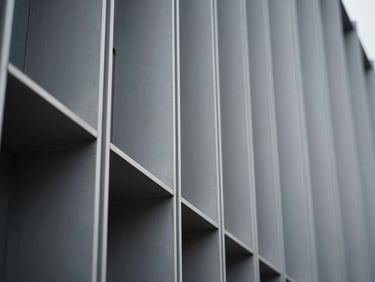 Close-up of interlocking aluminum facade profiles, cool overcast light, sharp focus, 35mm