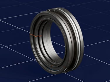 Crisp orthographic CAD rendering of a high-performance mechanical seal assembly, displaying detailed cross-sectional views and stress concentration zones, stark white grid lines over a deep navy background