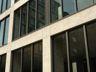Abstract architectural detail of a modern concrete and glass financial headquarters in Zurich, sharp angles, warm afternoon side-lighting
