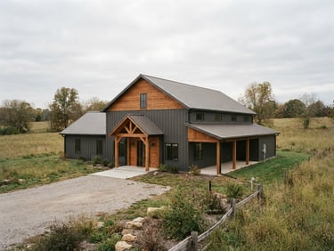 Wide-angle architectural exterior shot of a completed modern barndominium with dark metal siding and warm wood accents, integrated into a rural landscape, soft overcast daylight, 35mm lens.