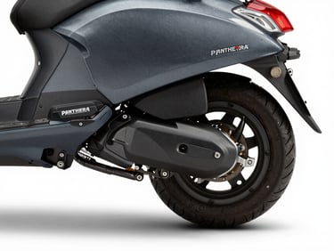 Side-angle close-up of Panthera scooter rear electromagnet housing and exhaust channel, cool studio strobe from the right, mechanical housing detail crisp, dark graphite finish, white studio ground