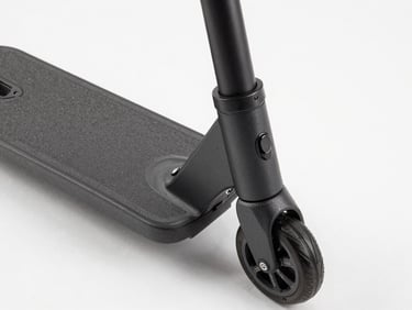 Tight overhead shot of Panthera scooter deck and handlebar stem on studio floor, north-facing strobe light, matte surface texture visible, control panel detail sharp, clean white backdrop