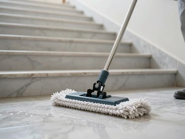 Close-up of a caretaker mopping a bright marble staircase in a Viennese apartment building, clean even light, mop head and wet floor tiles sharp in foreground