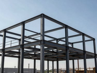 Structural steel framing of a commercial development under construction, crisp high-contrast midday sun, geometric composition.