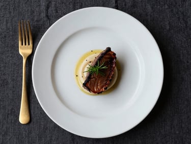 Overhead flat-lay of a single intimate dinner plate — a fine-dining main course composed with precision on a wide-rim white plate, dark linen beneath, one gold fork beside the plate, extreme close-up, surgical studio lighting with no shadow fill