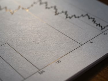 Close-up of heavy textured paper with blurred financial charts and precise geometric lines, low-key lighting, gold accents reflecting light.