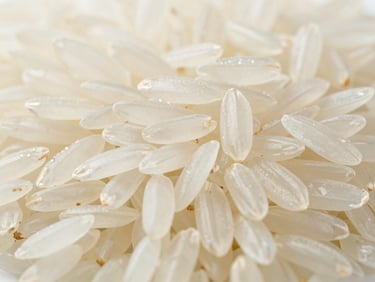 Macro shot of raw long-grain non-Basmati white rice grains, clean and uniform