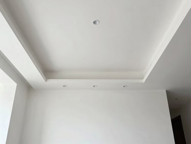 Straight-on architectural shot of a minimalist room with dynamic geometric recessed ceiling lighting, sharp drywall edges, bright daylight, 35mm lens