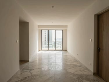 Wide-angle interior shot of an unfurnished Dubai apartment entry corridor, marble flooring transition visible, natural light entering from floor-to-ceiling windows at the far end, neutral architectural palette