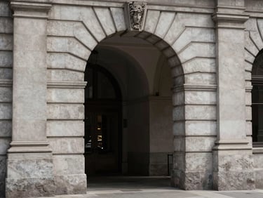 A quiet, historic stone archway in the San Francisco financial district, framed by clean lines and soft shadows.