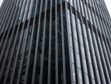 Abstract architectural perspective of a modern skyscraper facade, deep obsidian tones, sharp focus, 35mm
