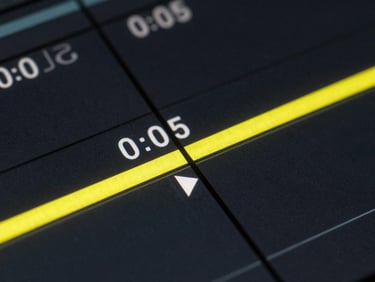 Macro shot of a video editing timeline scrub bar at the 0:05 mark, bright yellow playhead, high-contrast screen glow.