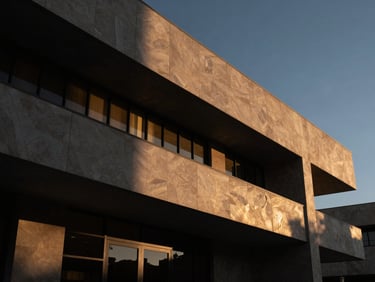 Low-angle architectural shot of a modern courthouse facade in Mexicali, sharp lines, dramatic side-lit shadows, deep charcoal and warm gold tones, low-key editorial photography.