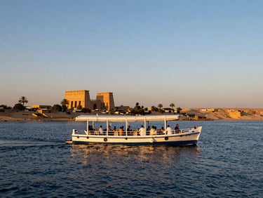 A private luxury dahabiya on the Nile at sunset, guests enjoying dinner on deck, soft golden light, ancient ruins in the distance, wide environmental shot.
