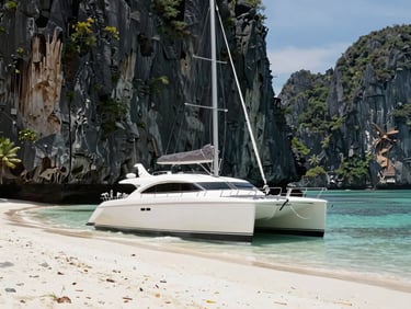 High-end luxury catamaran anchored off a private white-sand cove in Langkawi, dramatic limestone cliffs behind, bright clear daylight