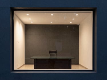 Modern minimalist law office interior in Puebla, sharp lines, professional glass table, warm interior lighting accent