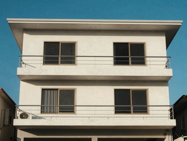 Exterior facade of a beach house in Cabo Frio, bright coastal sun, blue sky, simple architecture.