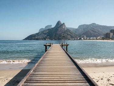 Bright environmental photo of Costa Azul beach in Rio das Ostras, showing the wooden pier stretching into the calm sea under sunny skies.