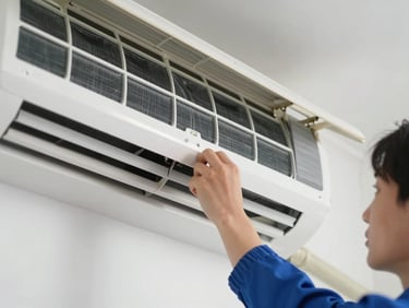 Close-up of a clean air conditioner unit on a white wall, a technician's hand adjusting the clean air filter inside, bright indoor light