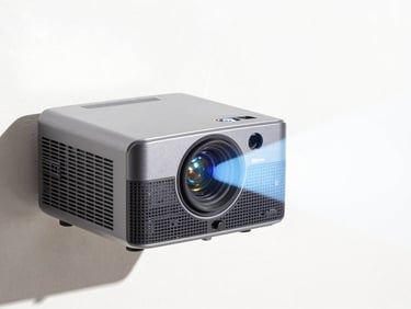 Close-up of a compact gray mini projector casting a bright image onto a white wall, bright high-key product photography, crisp natural daylight, vivid colors, sharp focus, 35mm