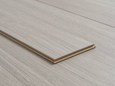 Close-up of premium indoor vinyl flooring planks, clean interlocking edges, neutral light gray wood grain