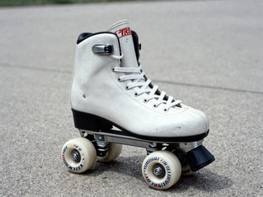 Archival scan of a vintage 90s Rollerblade TRS inline skate, close-up, desaturated tones, on a concrete background