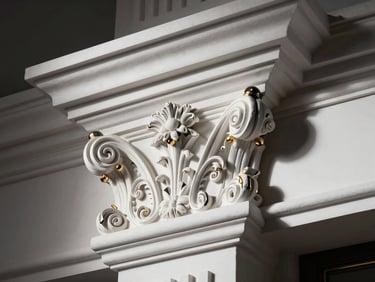 Extreme close-up of hand-carved neoclassical plaster cornice detailing, crisp white plaster against deep charcoal shadow, luxury editorial