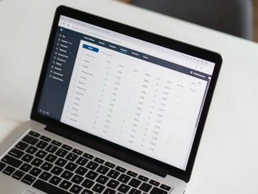 Overhead view of a performance analytics interface on a laptop screen showing ROAS and CPM metrics, clean white desk surface, ambient studio light, numbers sharp and legible