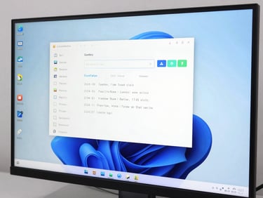 Clean computer monitor displaying a sleek operating system installation interface, bright studio environment, cool blue accents
